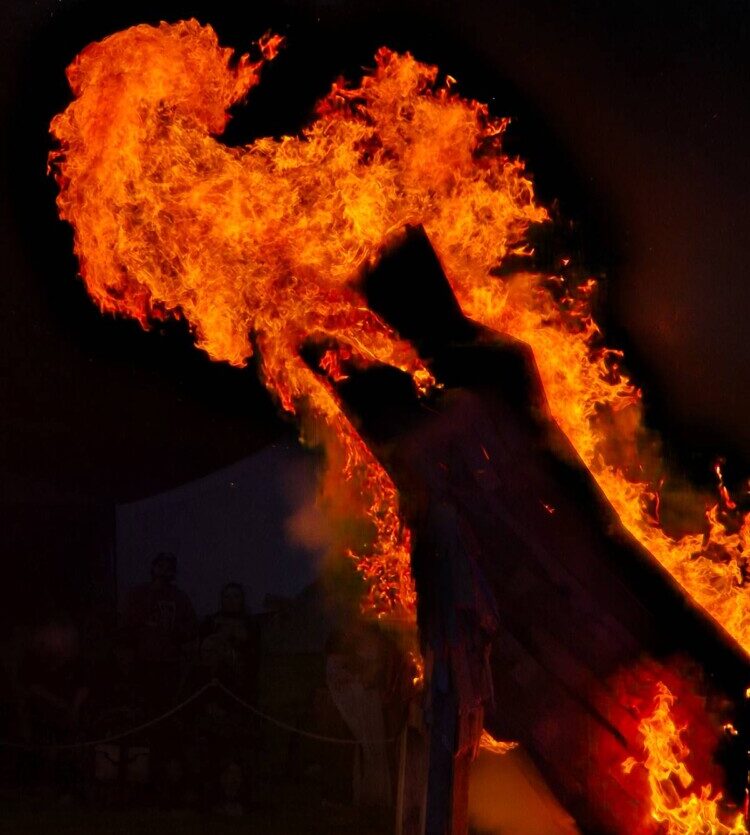 A burning wolf sculpture during Solskin Festival 2025